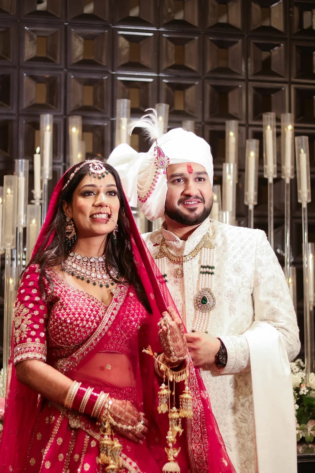 Bride and groom exchanging vows in an outdoor Indian wedding ceremony.